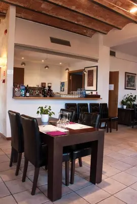 a dining room with a table and chairs at Hotel Moli De La Torre in Bigues i Riells