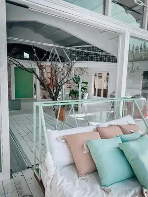 a couch sitting on a porch with pillows on it at Suite con Jacuzzi in Canyelles