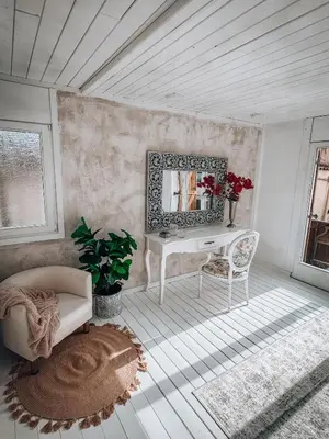 a living room with a table and a mirror at Suite con Jacuzzi in Canyelles