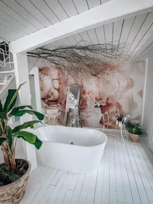 a bath tub in a bathroom with a mural of animals at Suite con Jacuzzi in Canyelles