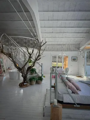 a bedroom with a bed and a tree in it at Suite con Jacuzzi in Canyelles