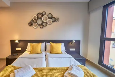 two beds in a room with plates on the wall at Bonavista Apartments - Virreina in Barcelona