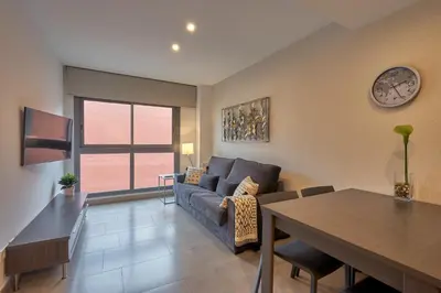 a living room with a couch and a table at Bonavista Apartments - Virreina in Barcelona