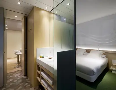 a bathroom with a sink and a toilet and a mirror at Ako Suite Hotel in Barcelona