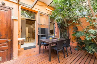 a wooden deck with a table and chairs on it at Montaber Apartment - Trafalgar in Barcelona
