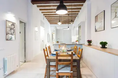 a kitchen and dining room with a table and chairs at Montaber Apartment - Trafalgar in Barcelona
