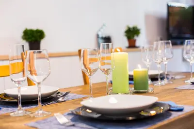a wooden table with wine glasses and candles on it at Montaber Apartment - Trafalgar in Barcelona