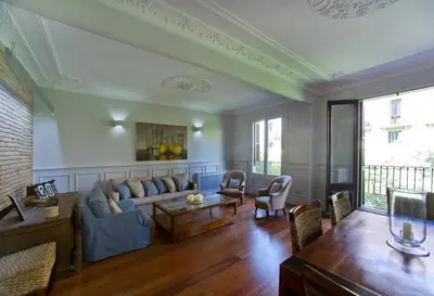 a living room with a couch and a table at Montaber Apartment - Bailén in Barcelona
