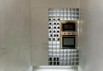 a kitchen with a stove and a bunch of wine bottles at Montaber Apartment - Bailén in Barcelona