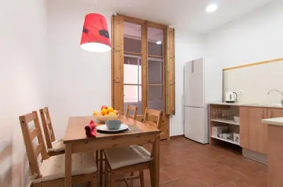 a kitchen with a table with a bowl of fruit on it at Montaber Apartment - Sant Antoni in Barcelona