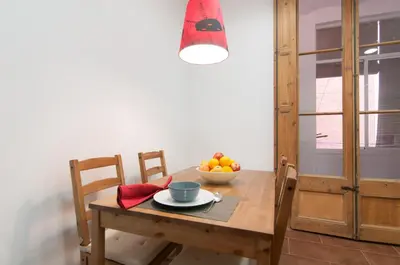 a wooden table with a bowl of fruit on it at Montaber Apartment - Sant Antoni in Barcelona
