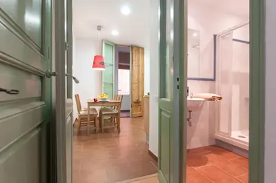 a hallway with a kitchen and a dining room at Montaber Apartment - Sant Antoni in Barcelona