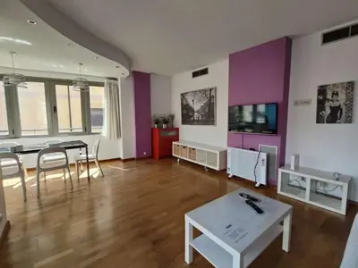 a living room with a table and a dining room at Sagrada Familia Apartment 265 in Barcelona
