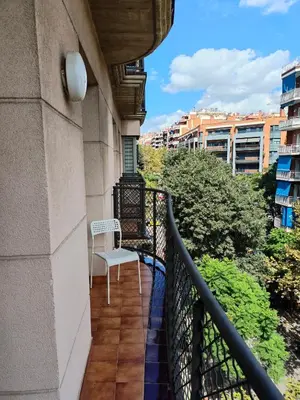 a balcony with a white chair on a building at Sagrada Familia Apartment 265 in Barcelona