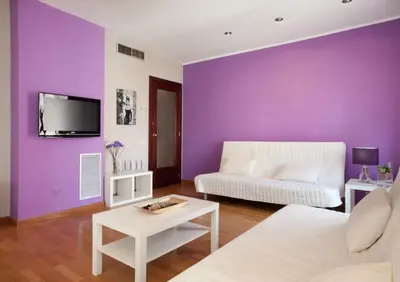 a living room with purple walls and a white couch at Sagrada Familia Apartment 265 in Barcelona