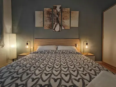 a bedroom with a large bed with two lamps on it at LG DownTown Sabadell Apartment in Sabadell