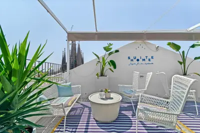an open balcony with a green lawn on a roof at Suite Home Sagrada Familia in Barcelona