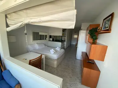a small room with a bed and a couch and a bed at The Moon Studio by Hello Homes Sitges in Sitges