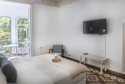 a bedroom with a bed and a tv on a wall at B-Garden BCN in Barcelona