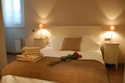a bedroom with a large bed with flowers on it at Montseny Suites & Apartments in Montseny