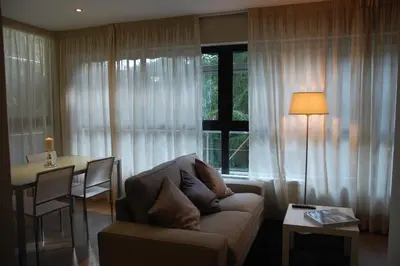 a living room with a couch and a table and a window at Montseny Suites & Apartments in Montseny