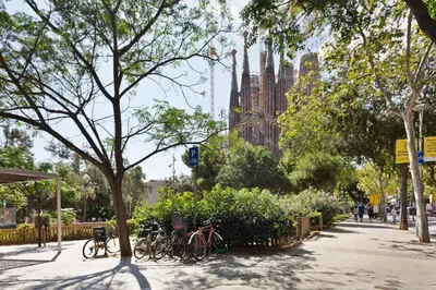 a group of bikes parked on a sidewalk in front of a cathedral at KeyFamily Paradise in Barcelona