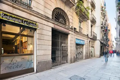 a person walking down a street in front of a store at KeyFamily Loft Las Ramblas in Barcelona
