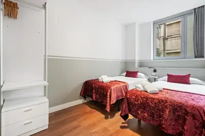 a bedroom with two beds and a mirror at Sensation Sagrada Familia in Barcelona