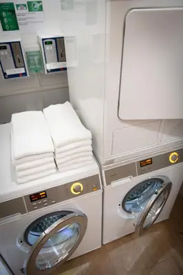 a washing machine and a washer and dryer on an airplane at Aura Park Aparthotel Fira Barcelona in Hospitalet de Llobregat