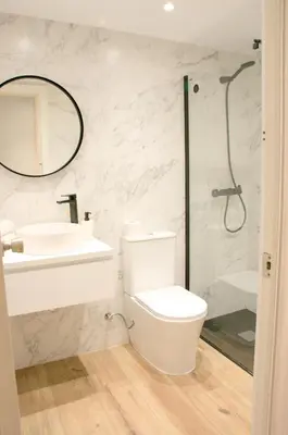 a bathroom with a toilet and a sink and a shower at Sweet BCN Three Bedroom Apartment in Barcelona