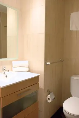 a bathroom with a sink and a toilet at Sweet BCN Three Bedroom Apartment in Barcelona