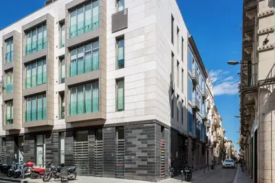 a building on a street with motorcycles parked in front at Modern and Trendy Duplex next to Paseo de Gracia in Barcelona