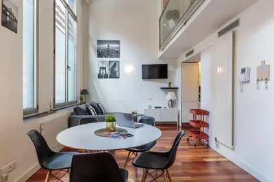 a living room with a table and chairs at Modern and Trendy Duplex next to Paseo de Gracia in Barcelona