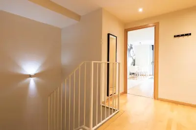 a staircase in a house with a mirror at AB Park Güell-Gaudi in Barcelona