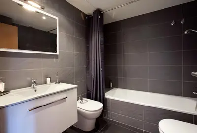 a bathroom with a sink and a toilet and a bath tub at AB Park Güell-Gaudi in Barcelona