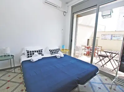 a bedroom with a large bed with blue sheets at La casa del Pi · La casa del Pi · House in the city, next to Barcelona and beach in Badalona