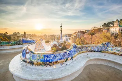 a bench covered in blue and white tiles in front of a city at easyHotel Barcelona Fira in Hospitalet de Llobregat