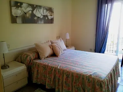 a bedroom with a bed with pillows on it at Apartament Mare Nostrum in Sitges