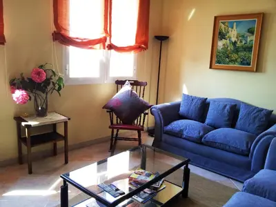 a living room with a blue couch and a table at Apartament Mare Nostrum in Sitges