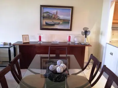a glass table with chairs and a desk in a room at Apartament Mare Nostrum in Sitges