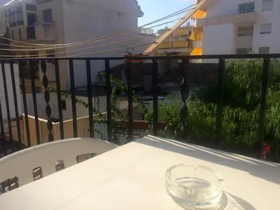 a glass sitting on a table on a balcony at Apartament Mare Nostrum in Sitges