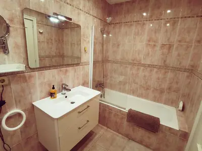 a bathroom with a sink and a shower and a mirror at Apartament Mare Nostrum in Sitges