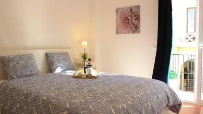 a bedroom with a bed and a window at Sitges Apartment in Sitges