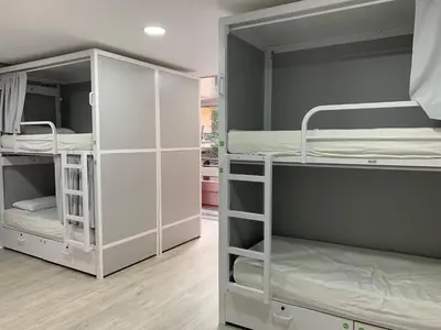 two white bunk beds in a room at Alberguinn in Barcelona