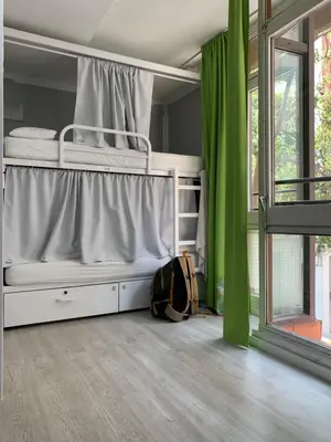 a bedroom with two bunk beds and a window at Alberguinn in Barcelona