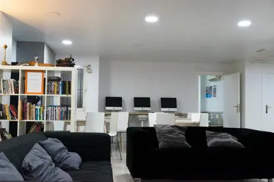 a living room with a couch and tables and chairs at Alberguinn in Barcelona