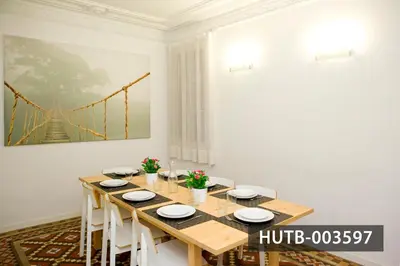 a dining room with a wooden table with white chairs at Big Apartment Barcelona Gran via in Barcelona