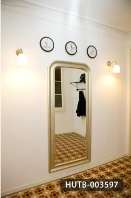a mirror in a room with clocks on the wall at Big Apartment Barcelona Gran via in Barcelona