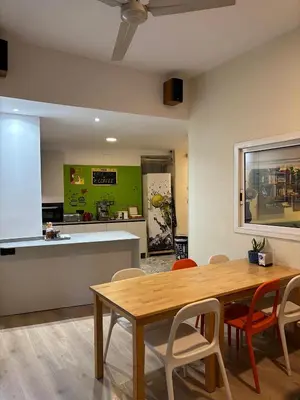 a kitchen and dining room with a table and chairs at Itaca Hostel in Barcelona