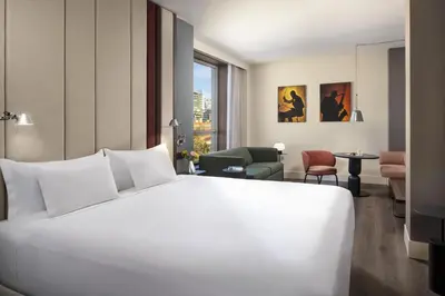 a large white bed in a hotel room at NH Barcelona Diagonal Center in Barcelona